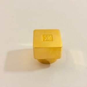 Maison Francis Kurkdjian parfume bottle cap in gold color.